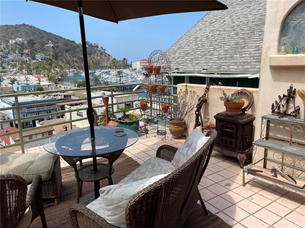 183 Lower Terrace Road Avalon, CA 90704 - Photo 16 of 33 a balcony with furniture and a potted plant