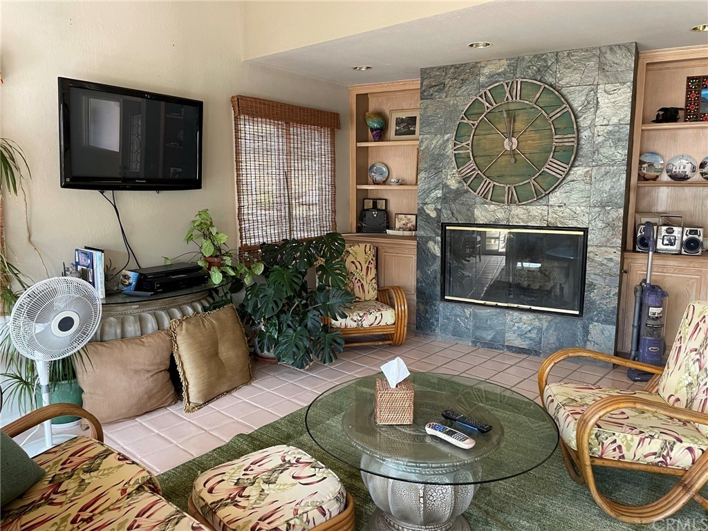 183 Lower Terrace Road Avalon, CA 90704 - Photo 17 of 33 a living room with furniture a flat screen tv and a fireplace