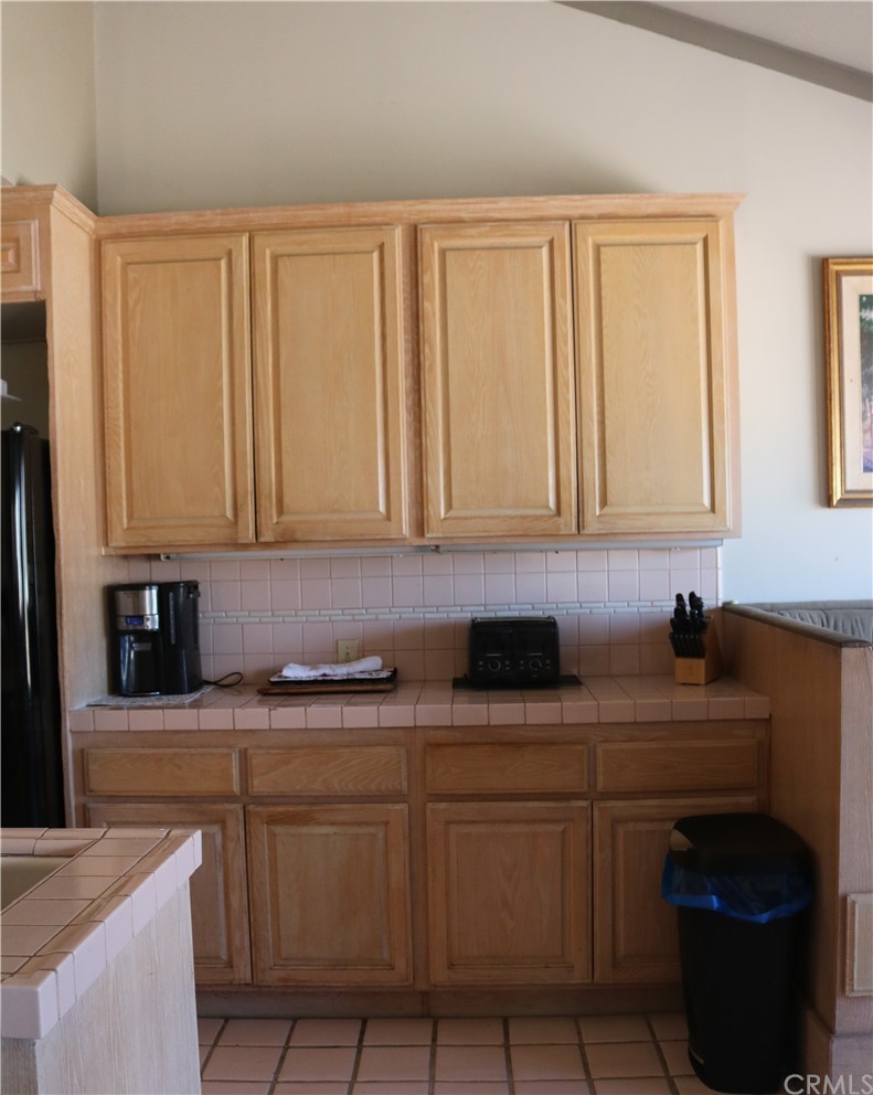 183 Lower Terrace Road Avalon, CA 90704 - Photo 24 of 33 a kitchen with stainless steel appliances granite countertop white cabinets sink and dishwasher