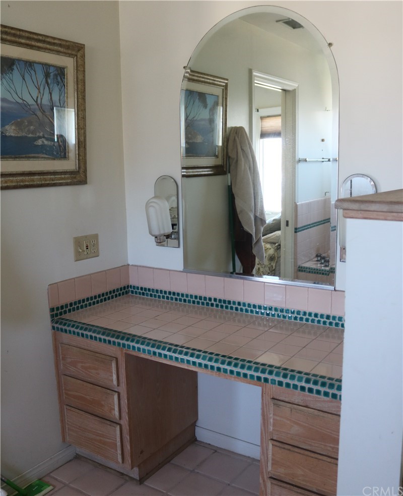 183 Lower Terrace Road Avalon, CA 90704 - Photo 27 of 33 a utility room with a sink a mirror and cabinets