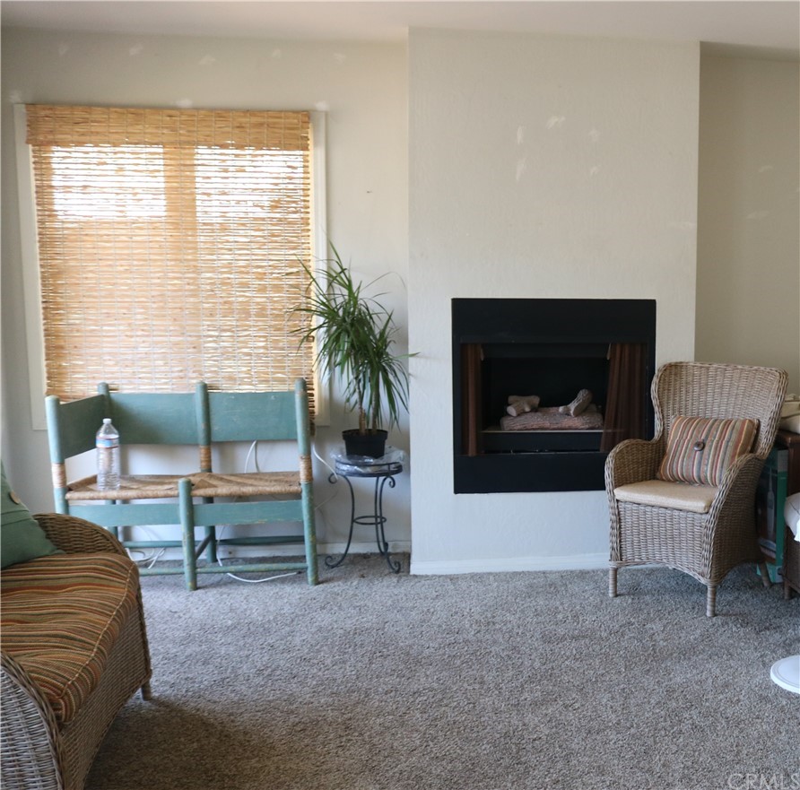 183 Lower Terrace Road Avalon, CA 90704 - Photo 31 of 33 a living room with furniture a window and a fireplace