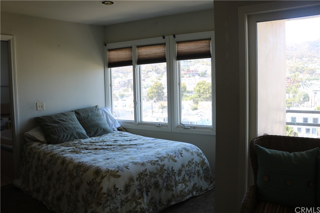 183 Lower Terrace Road Avalon, CA 90704 - Photo 33 of 33 a large bed sitting in a bedroom next to a window
