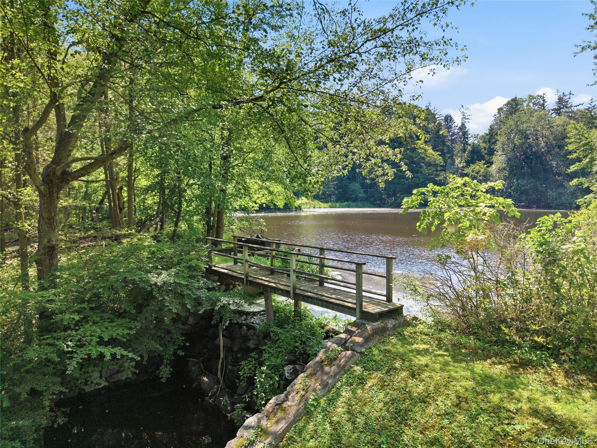 18 Salem Road Pound Ridge, NY 10576 - Photo 3 of 27 Picturesque pond with bridge and private dock