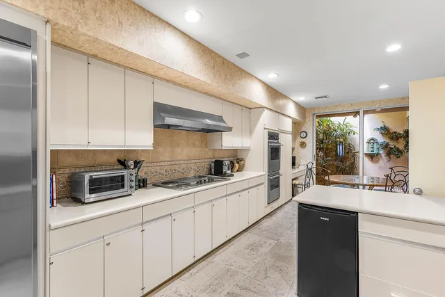 a kitchen with stainless steel appliances a sink stove and cabinets