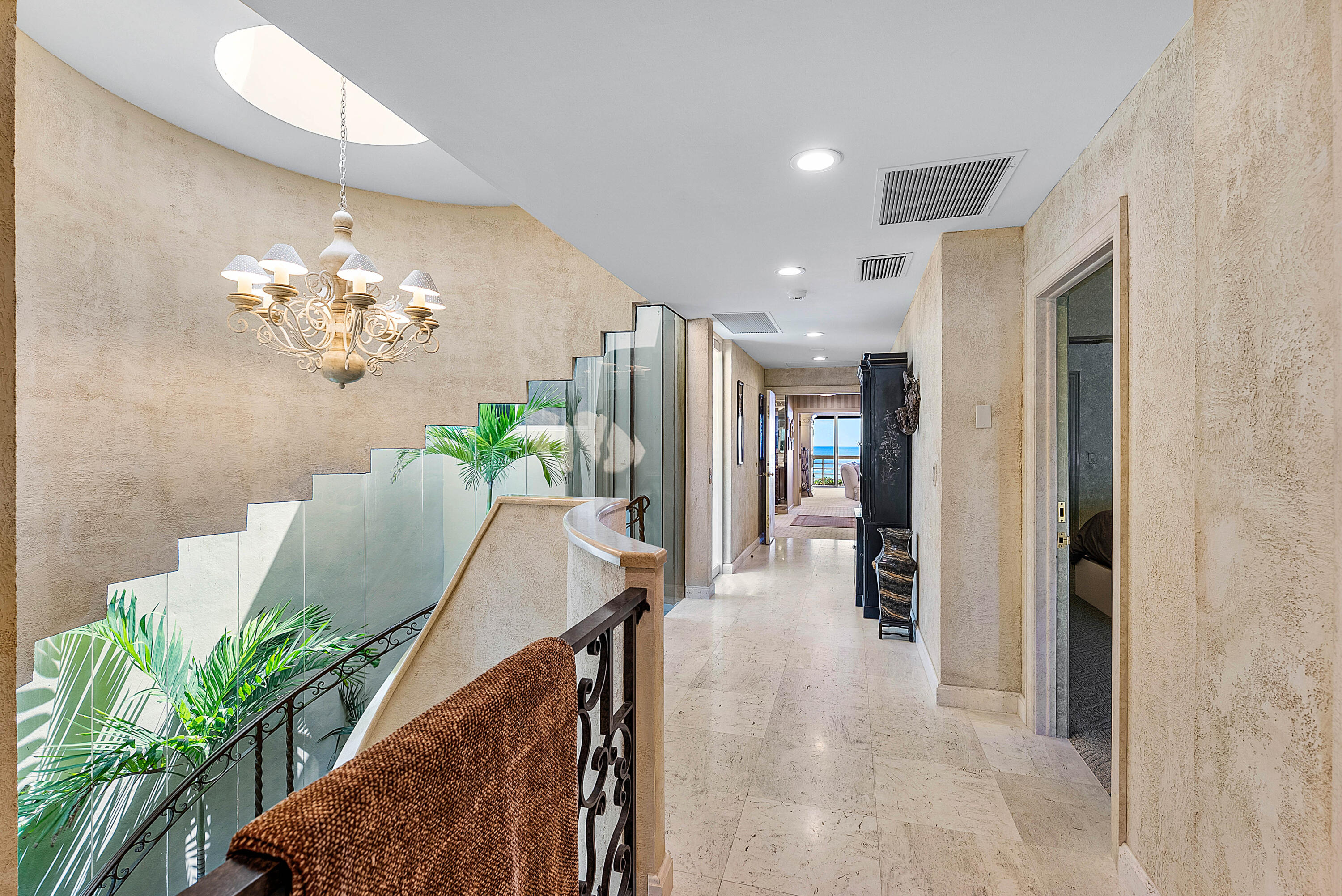 13 Sloans Curve Drive, Unit 13 Palm Beach, FL 33480 - Photo 20 of 47 a lobby with furniture and a chandelier