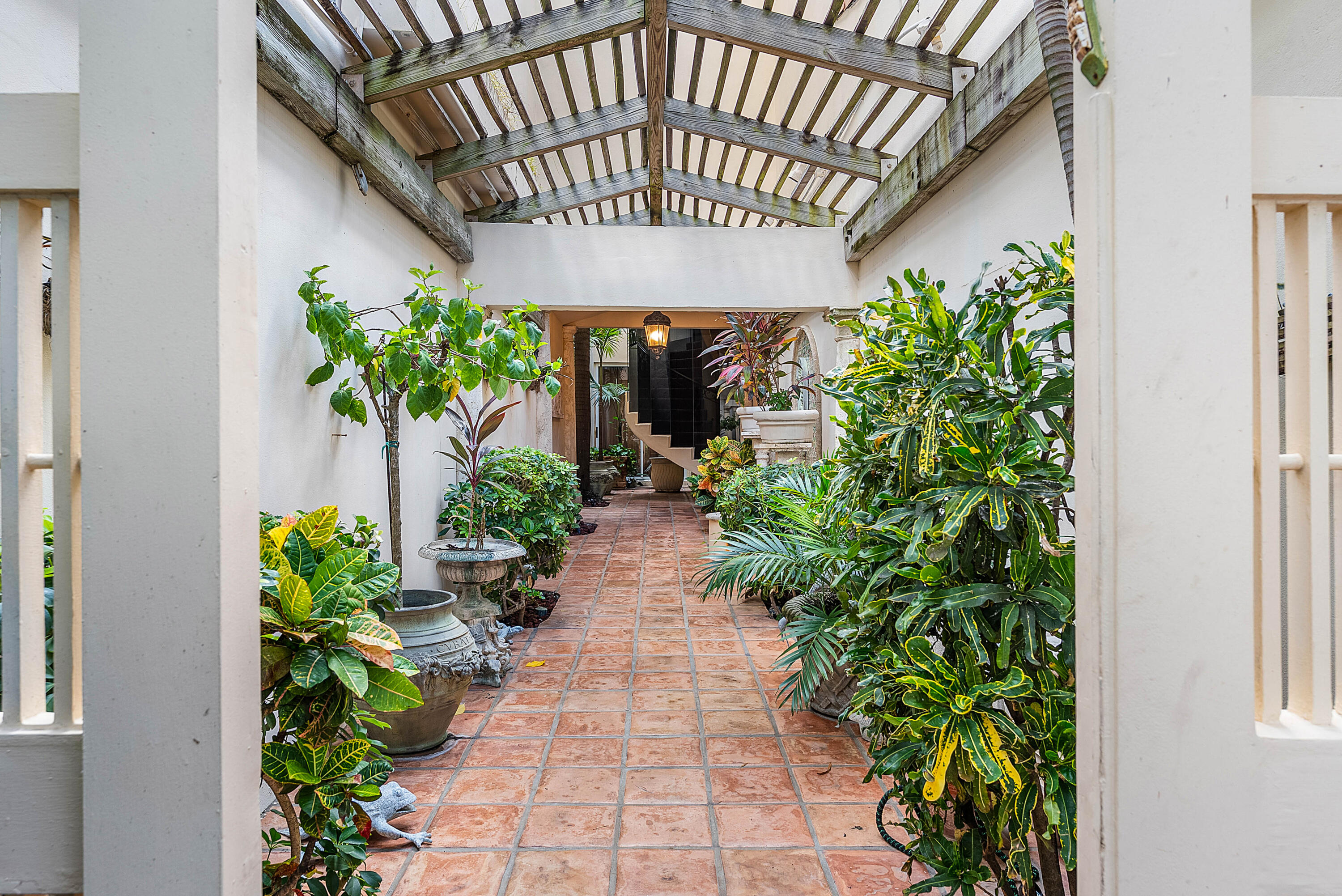 13 Sloans Curve Drive, Unit 13 Palm Beach, FL 33480 - Photo 2 of 47 a view of a pathway with a flower pot