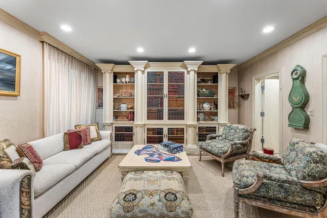 a living room with furniture chess table and a window