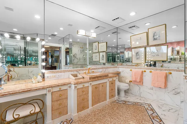 a dining hall with stainless steel appliances kitchen island granite countertop a sink and cabinets