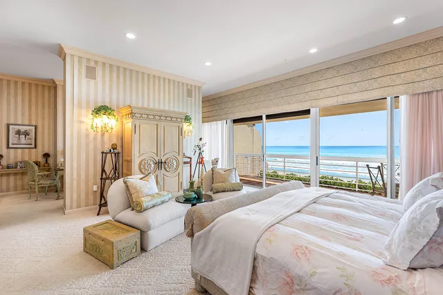 a spacious bedroom with a bed and a couch