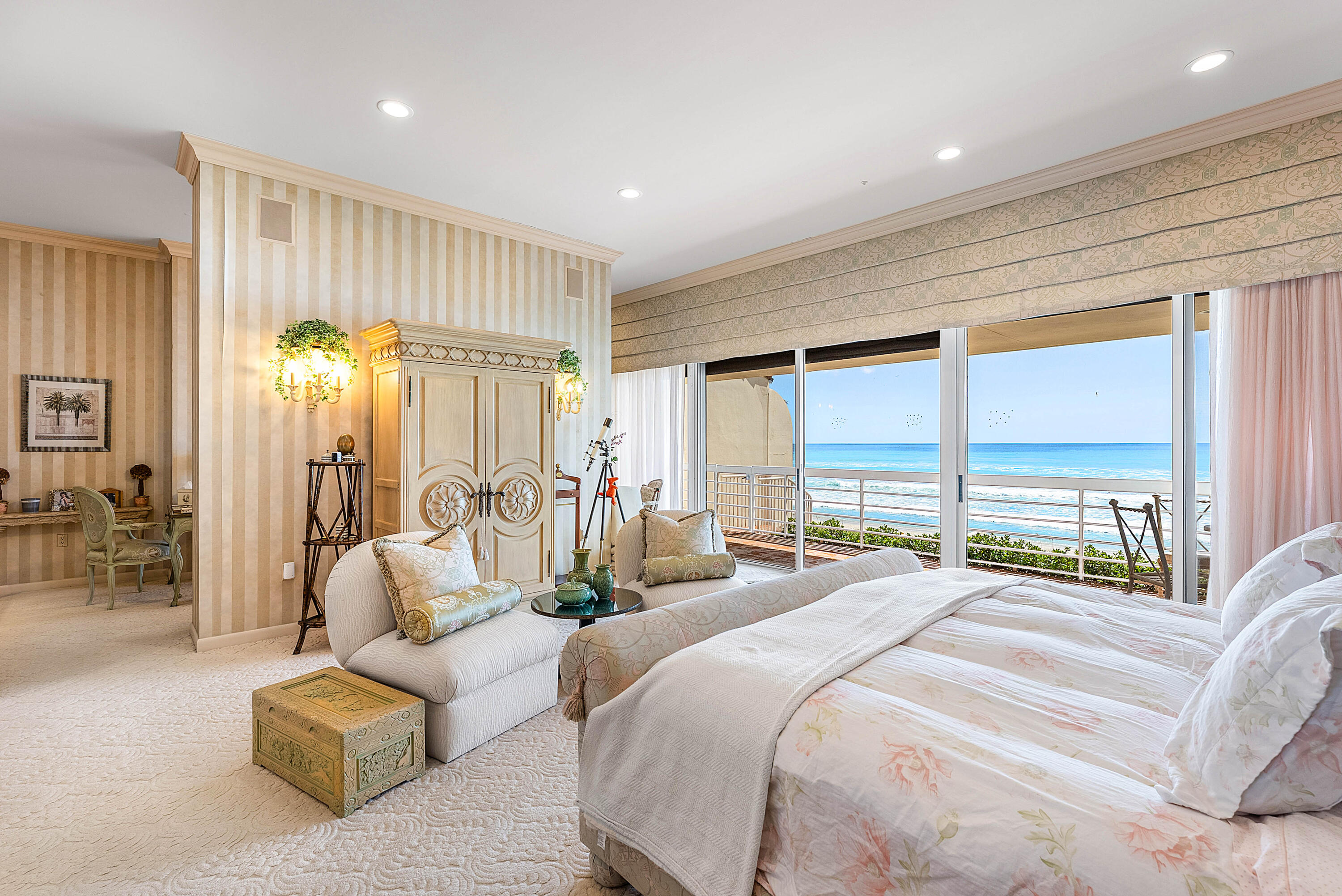 13 Sloans Curve Drive, Unit 13 Palm Beach, FL 33480 - Photo 30 of 47 a spacious bedroom with a bed and a couch