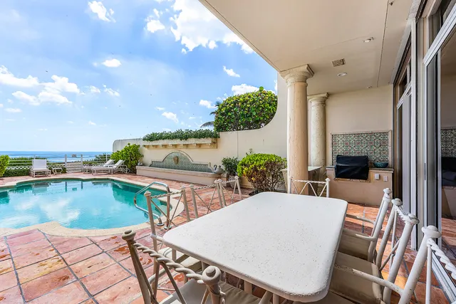 swimming pool view with a seating space