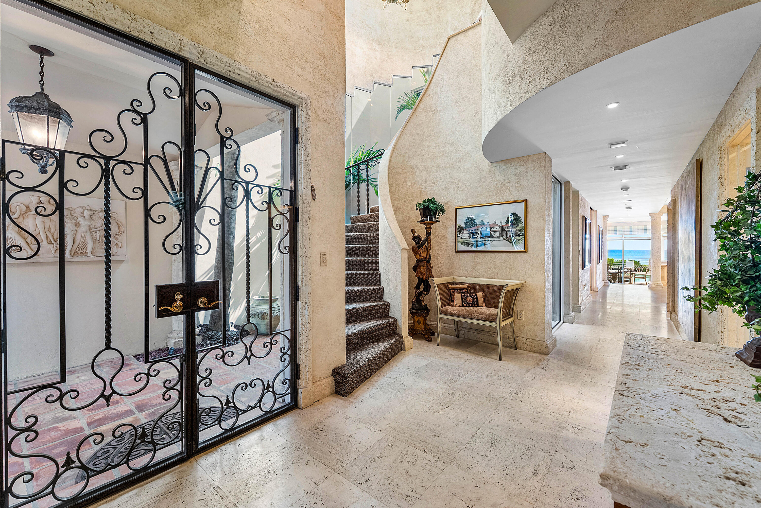 13 Sloans Curve Drive, Unit 13 Palm Beach, FL 33480 - Photo 4 of 47 a view of a hallway with stairs and furniture