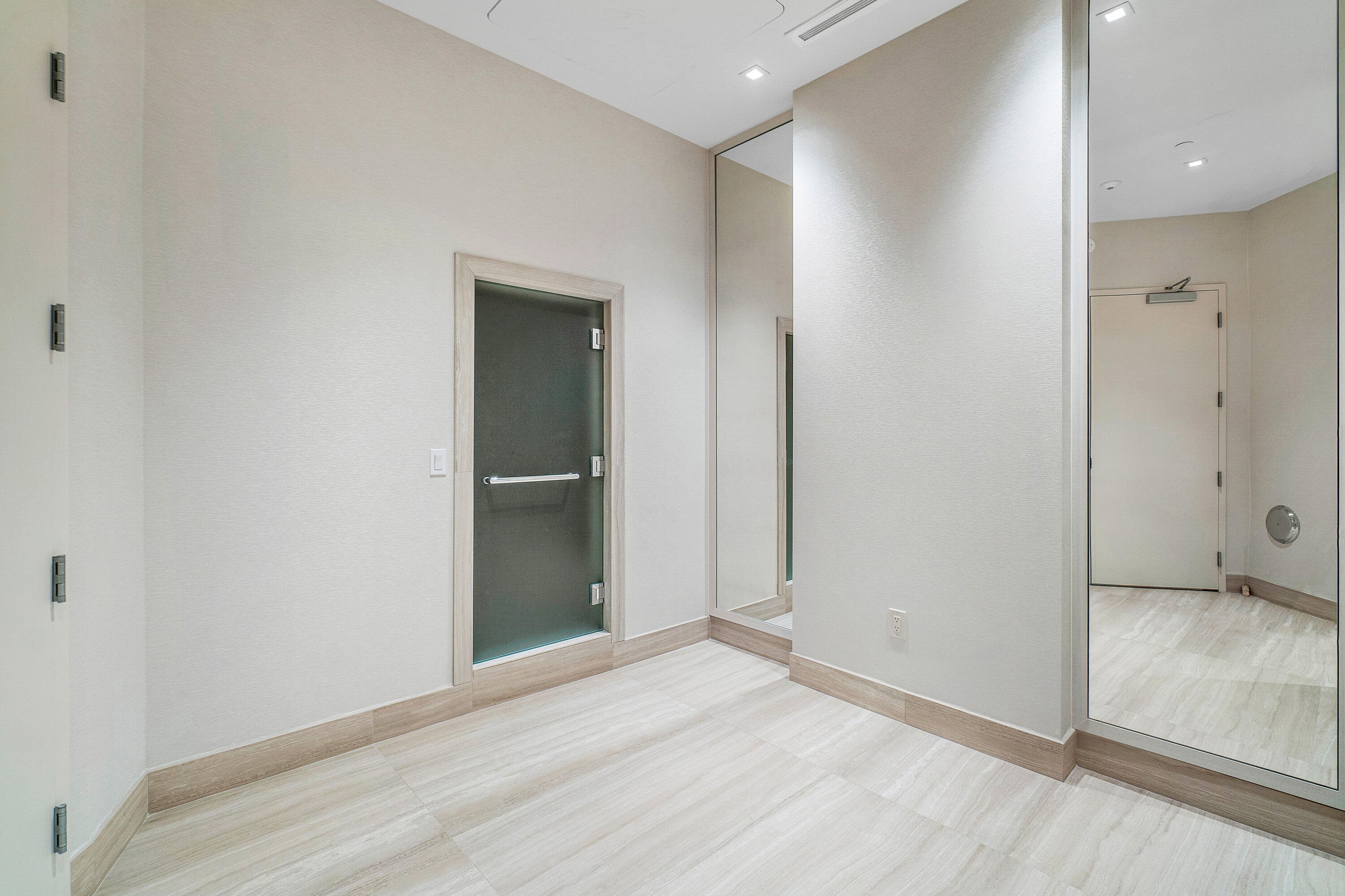 13 Sloans Curve Drive, Unit 13 Palm Beach, FL 33480 - Photo 45 of 47 a view of an empty room with wooden floor