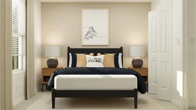 a bedroom with a bed and painting on the wall