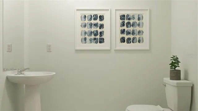 a bathroom with a sink mirror and toilet