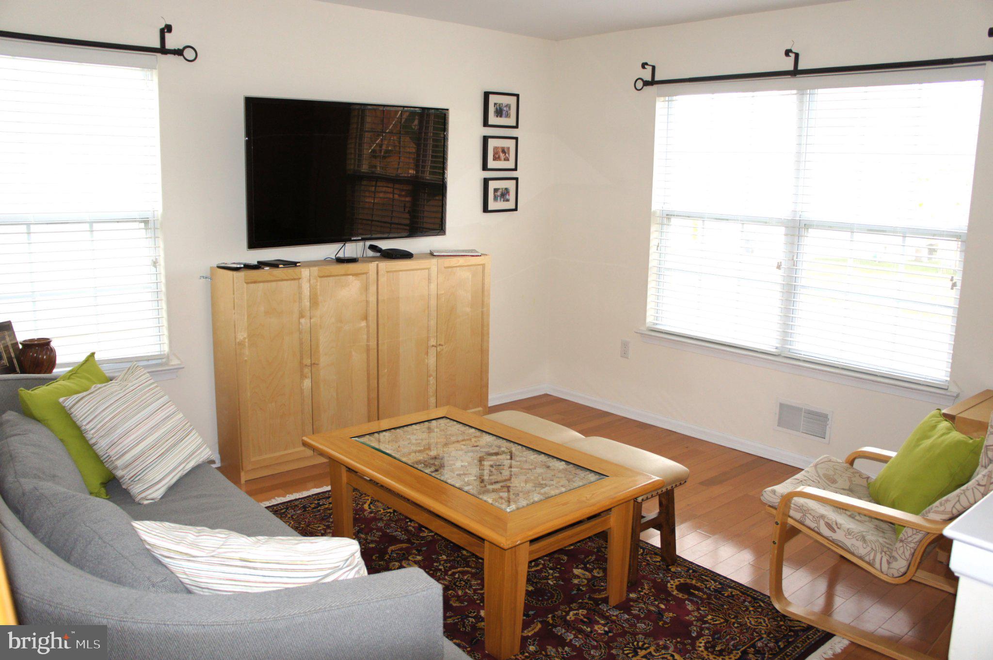 30 Richards Road Lawrenceville, NJ 08648 - Photo 11 of 11 a living room with a table and a flat screen tv