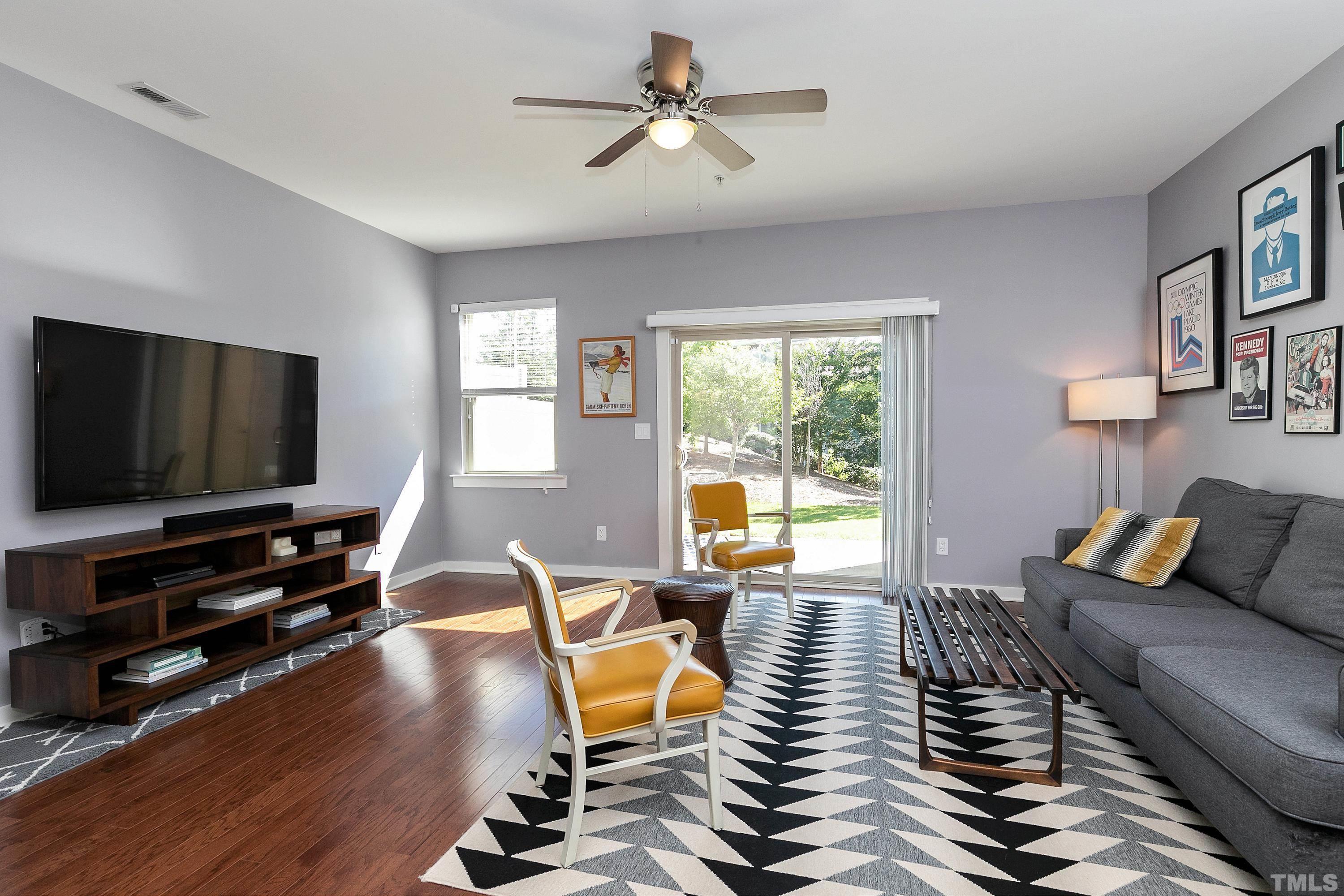 7906 Allscott Way Raleigh, NC 27612 - Photo 12 of 30 a living room with furniture and a flat screen tv