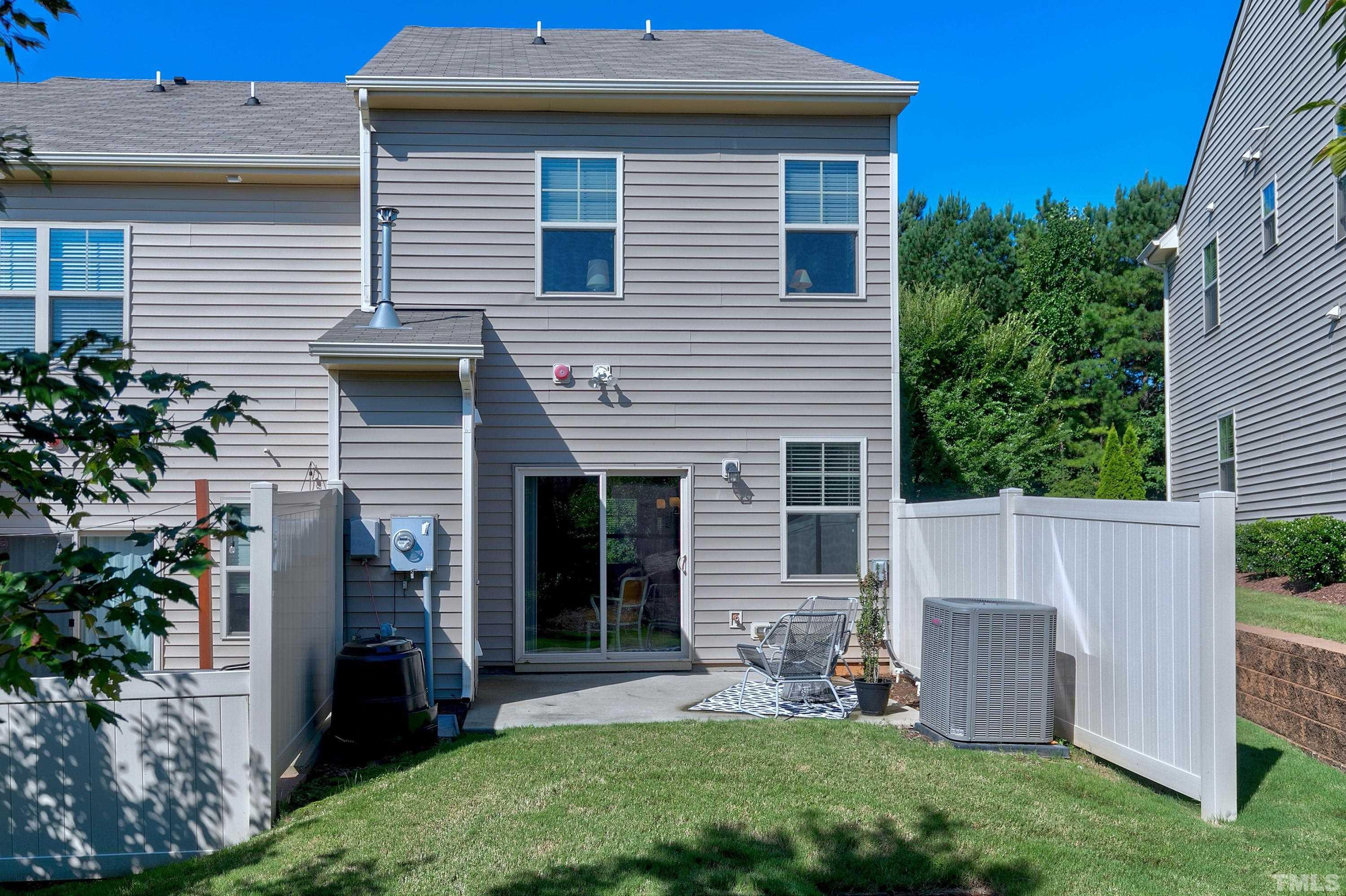 7906 Allscott Way Raleigh, NC 27612 - Photo 25 of 30 a view of house with a yard and chair