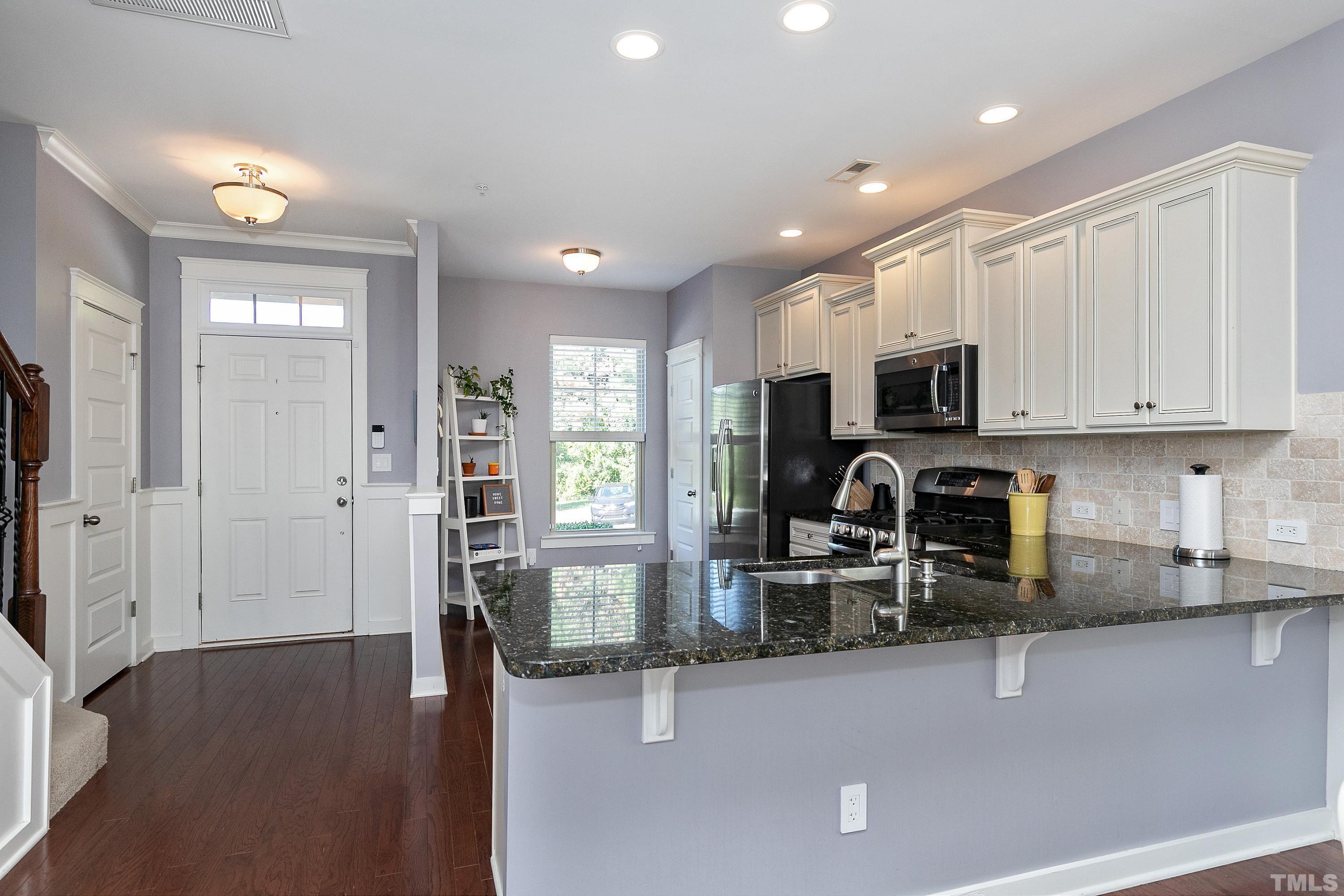 7906 Allscott Way Raleigh, NC 27612 - Photo 6 of 30 a kitchen with sink a microwave and cabinets