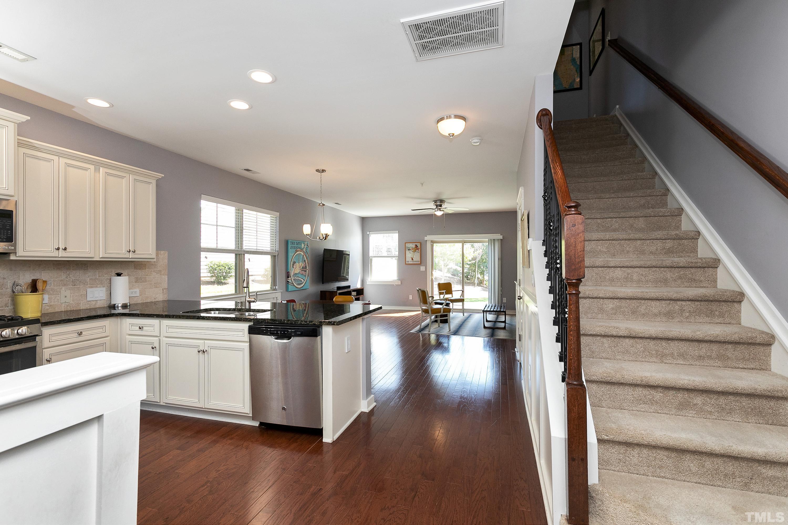 7906 Allscott Way Raleigh, NC 27612 - Photo 8 of 30 a kitchen with sink cabinets and wooden floor