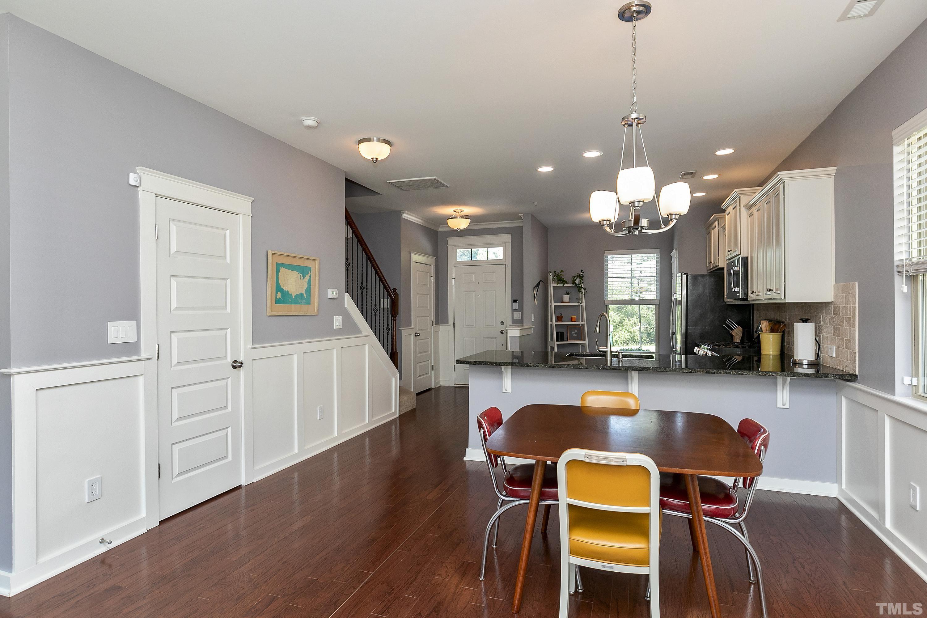 7906 Allscott Way Raleigh, NC 27612 - Photo 9 of 30 a view of a dining room with furniture and wooden floor