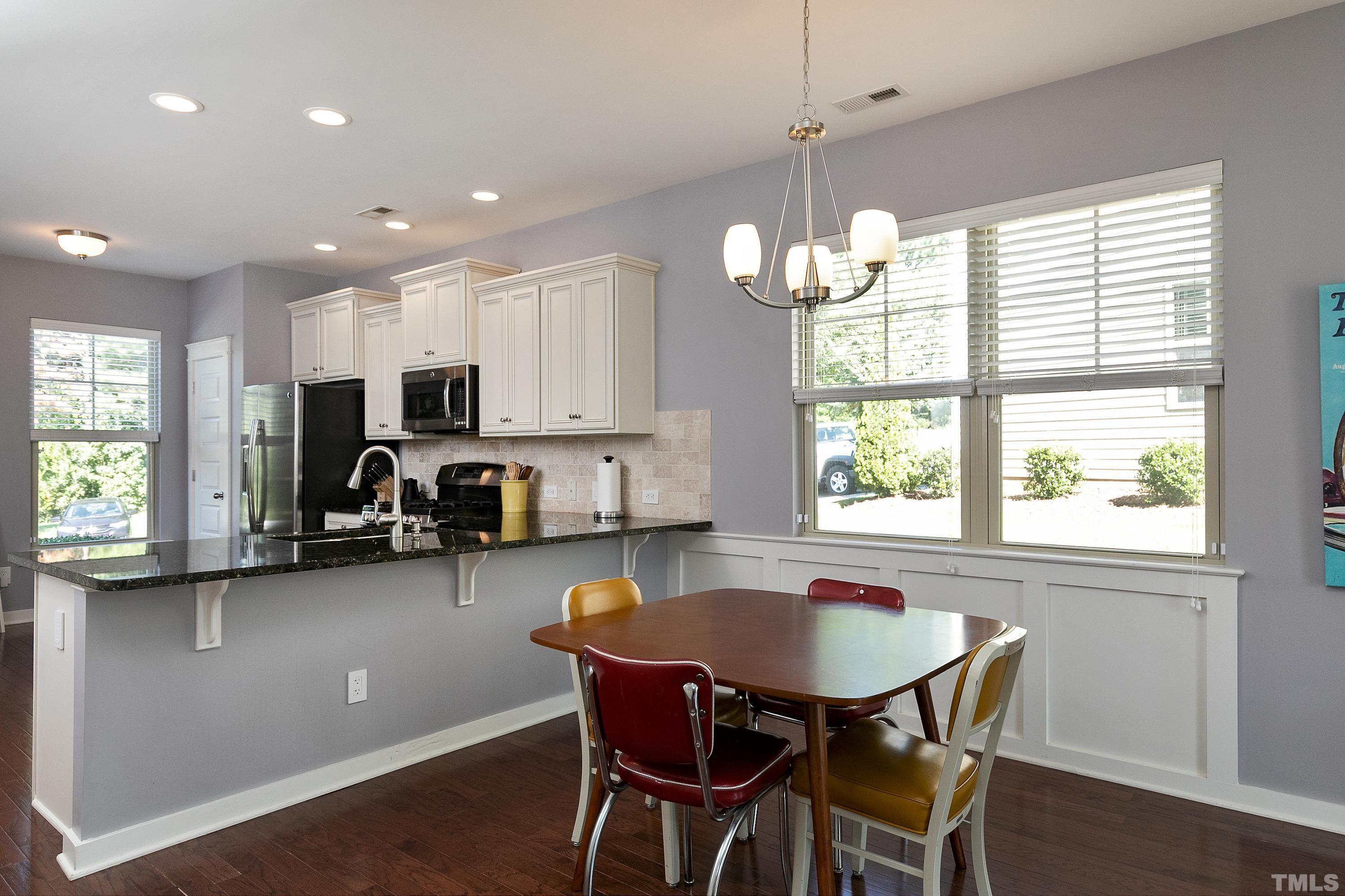 7906 Allscott Way Raleigh, NC 27612 - Photo 10 of 30 a kitchen with sink a window and chairs