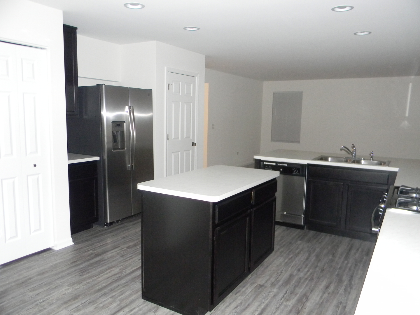6616 Eich Drive Joliet, IL 60431 - Photo 6 of 20 a kitchen with a sink refrigerator and wooden floor