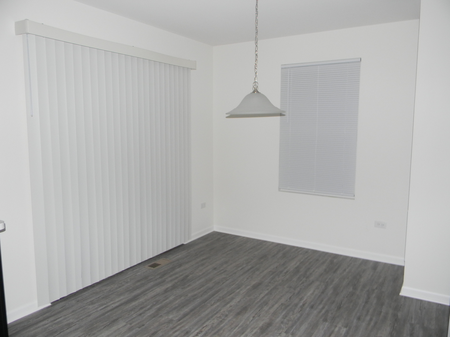 6616 Eich Drive Joliet, IL 60431 - Photo 9 of 20 a view of an empty room with wooden floor and a window