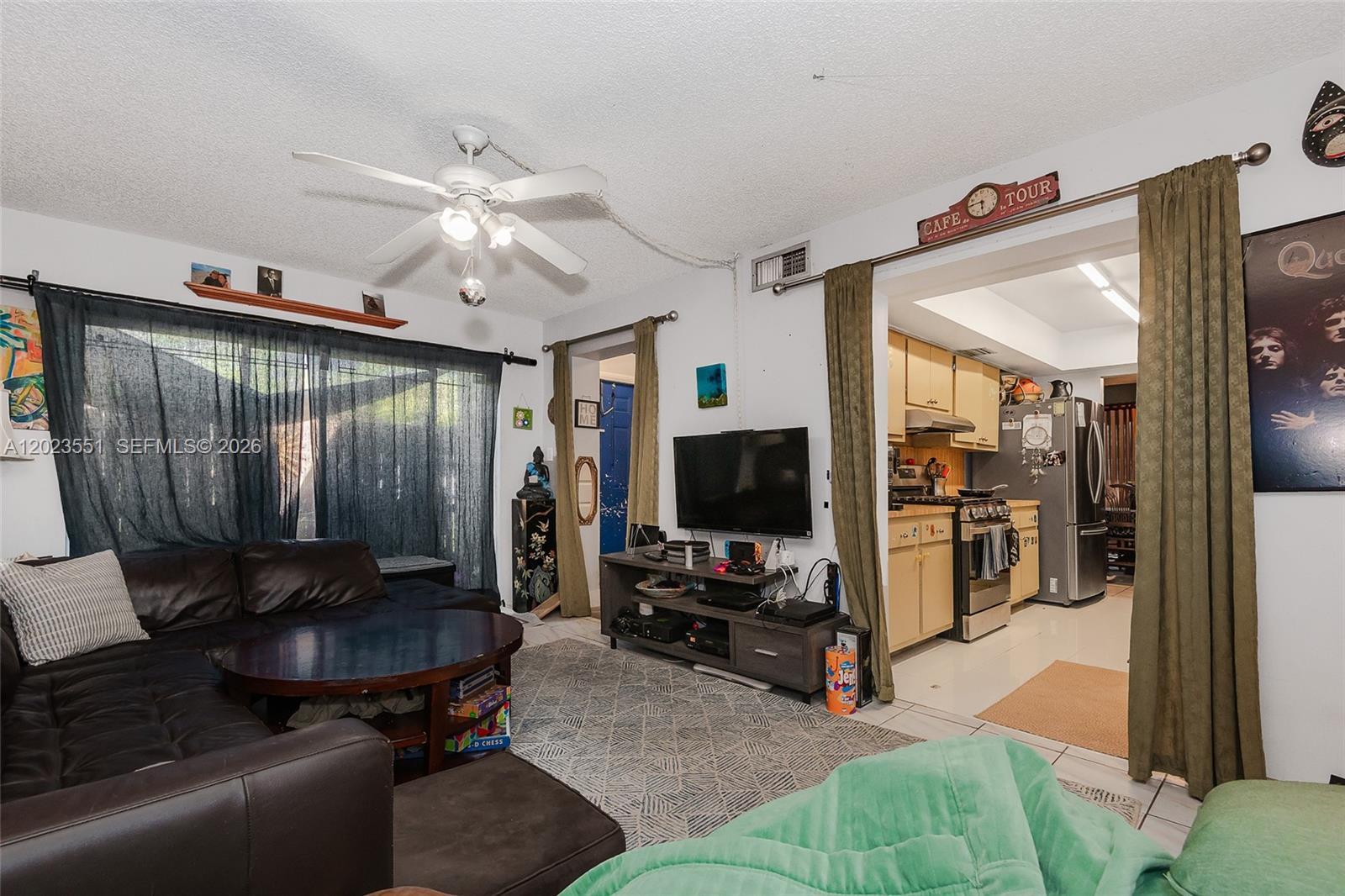11482 Southwest 109th Road, Unit 29A Miami, FL 33176 - Photo 13 of 28 a living room with furniture and a flat screen tv