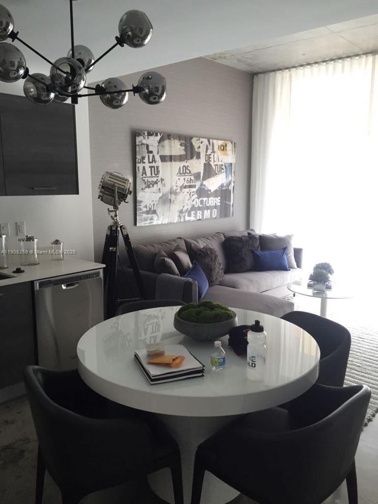 151 Southeast 1st Street, Unit 903 Miami, FL 33131 - Photo 1 of 8 a dining room with furniture and window