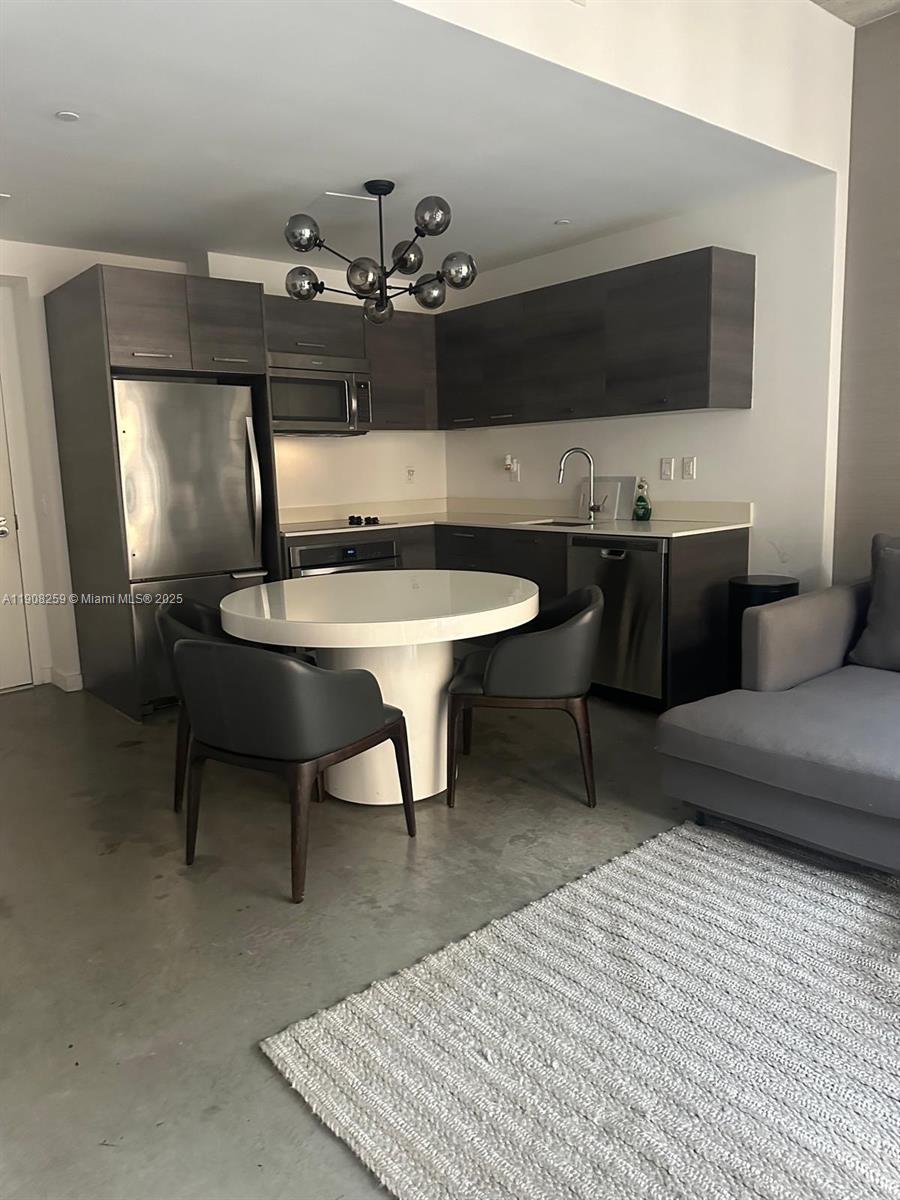 151 Southeast 1st Street, Unit 903 Miami, FL 33131 - Photo 2 of 8 a living room with furniture and a flat screen tv