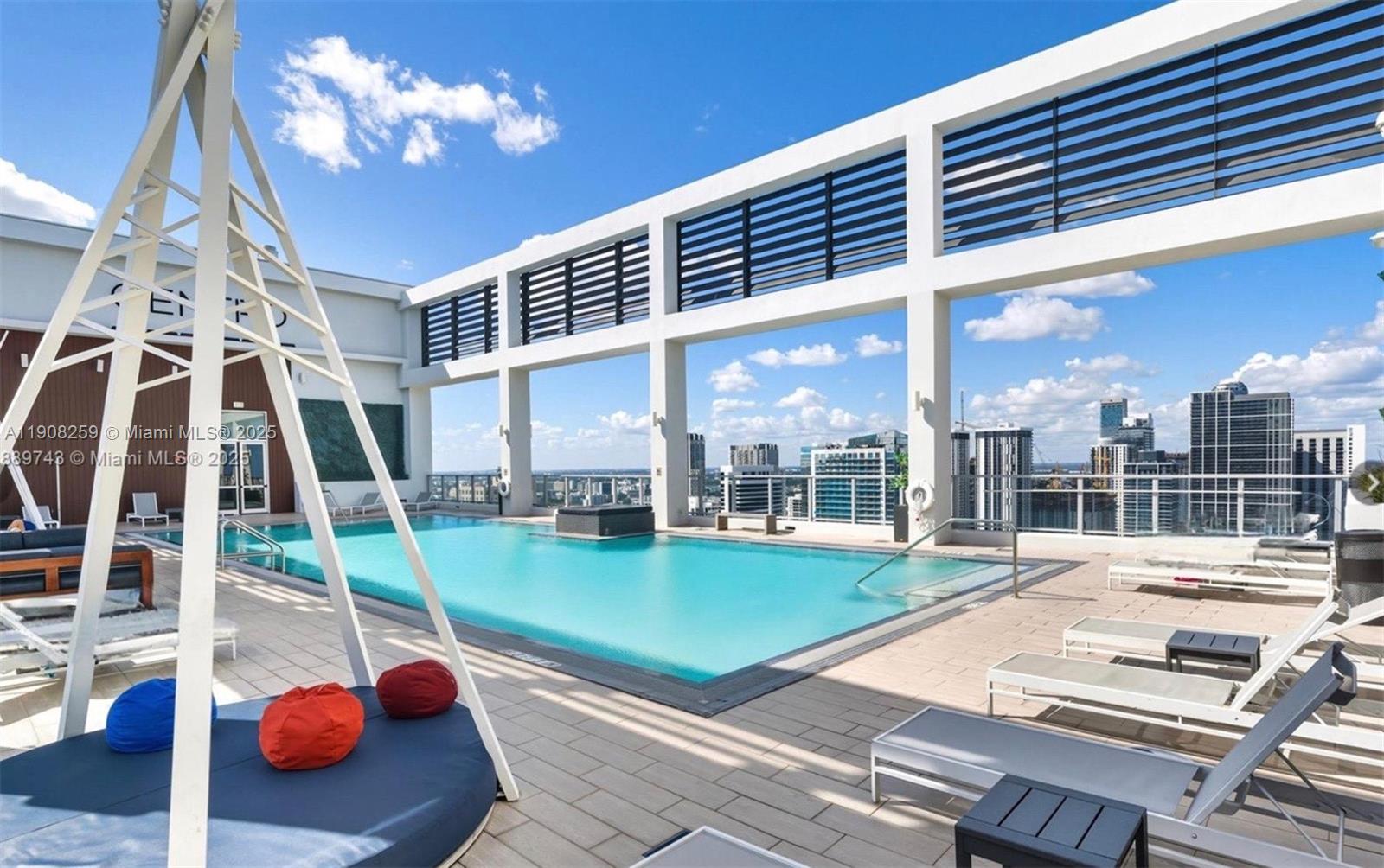 151 Southeast 1st Street, Unit 903 Miami, FL 33131 - Photo 8 of 8 a view of a patio with a dining table and chairs with swimming pool