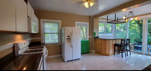 a kitchen with refrigerator and window
