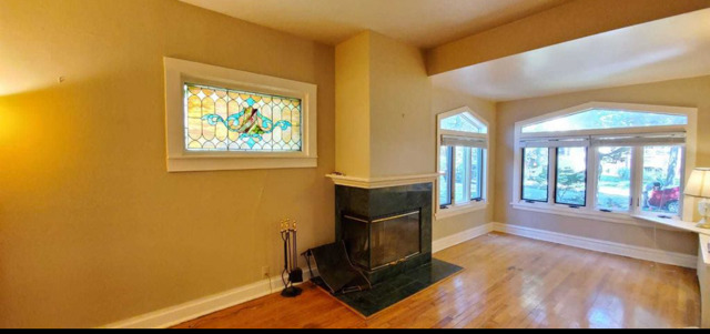 2118 Noyes Street, Unit 1 Evanston, IL 60201 - Photo 8 of 11 a living room with hard wood floors and a kitchen