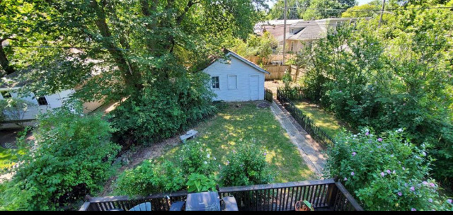 2118 Noyes Street, Unit 1 Evanston, IL 60201 - Photo 10 of 11 a wooden fence with trees in the background