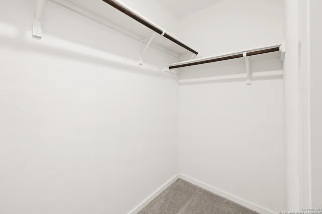 a view of an empty room and a window