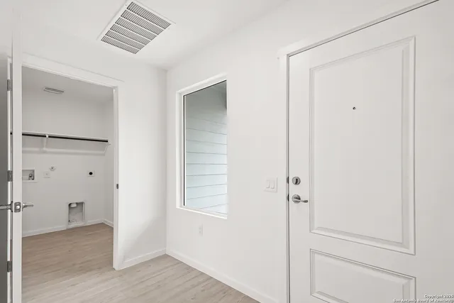 a kitchen with stainless steel appliances granite countertop a sink and cabinets with wooden floors