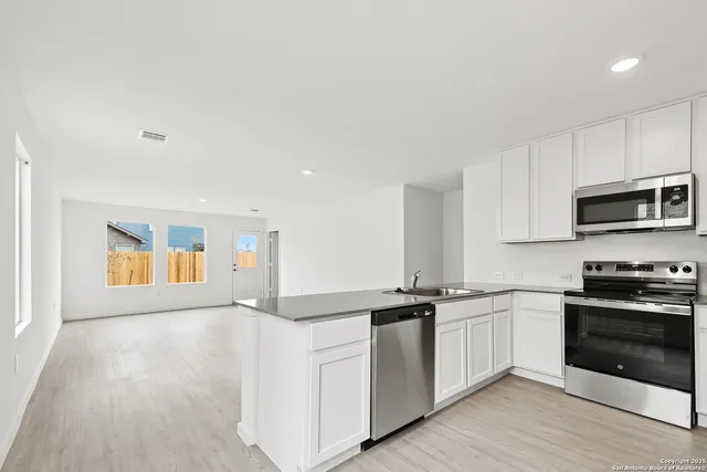 a kitchen with a sink and cabinets