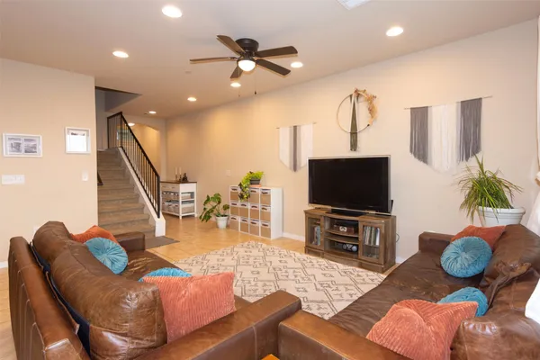 a bedroom with a bed and a ceiling fan