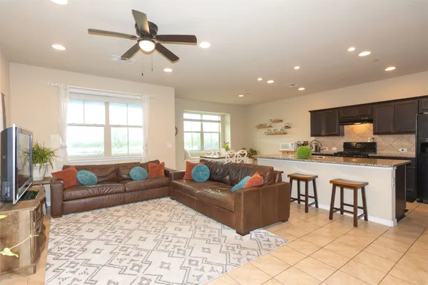 a living room with furniture windows and a flat screen tv