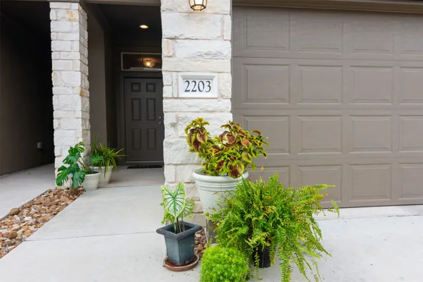 a view of staircase with white walls and a painting