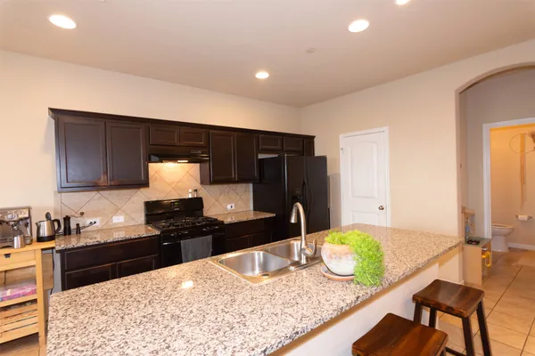 a spacious bedroom with a bed and a flat screen tv