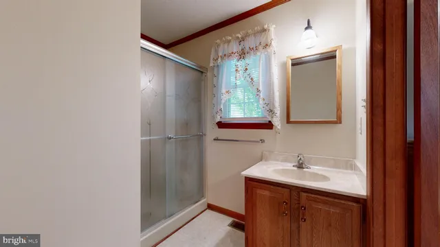 a furnished livingroom with windows and chandelier fan