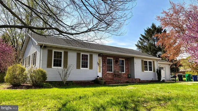 a view of an empty room with stairs and a couch