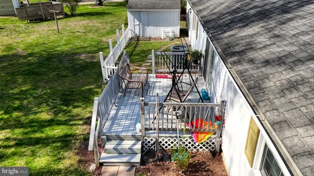 a view of balcony with wooden floor and fence