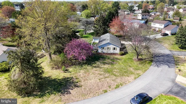 an aerial view of a house with a yard swimming pool and outdoor seating