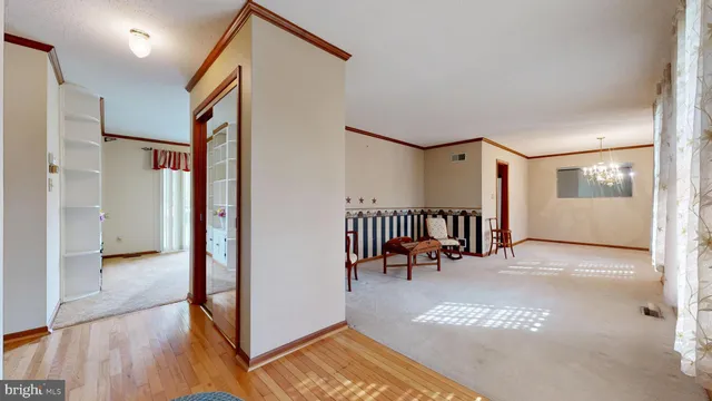 a view of a livingroom with a chandelier and a chandelier