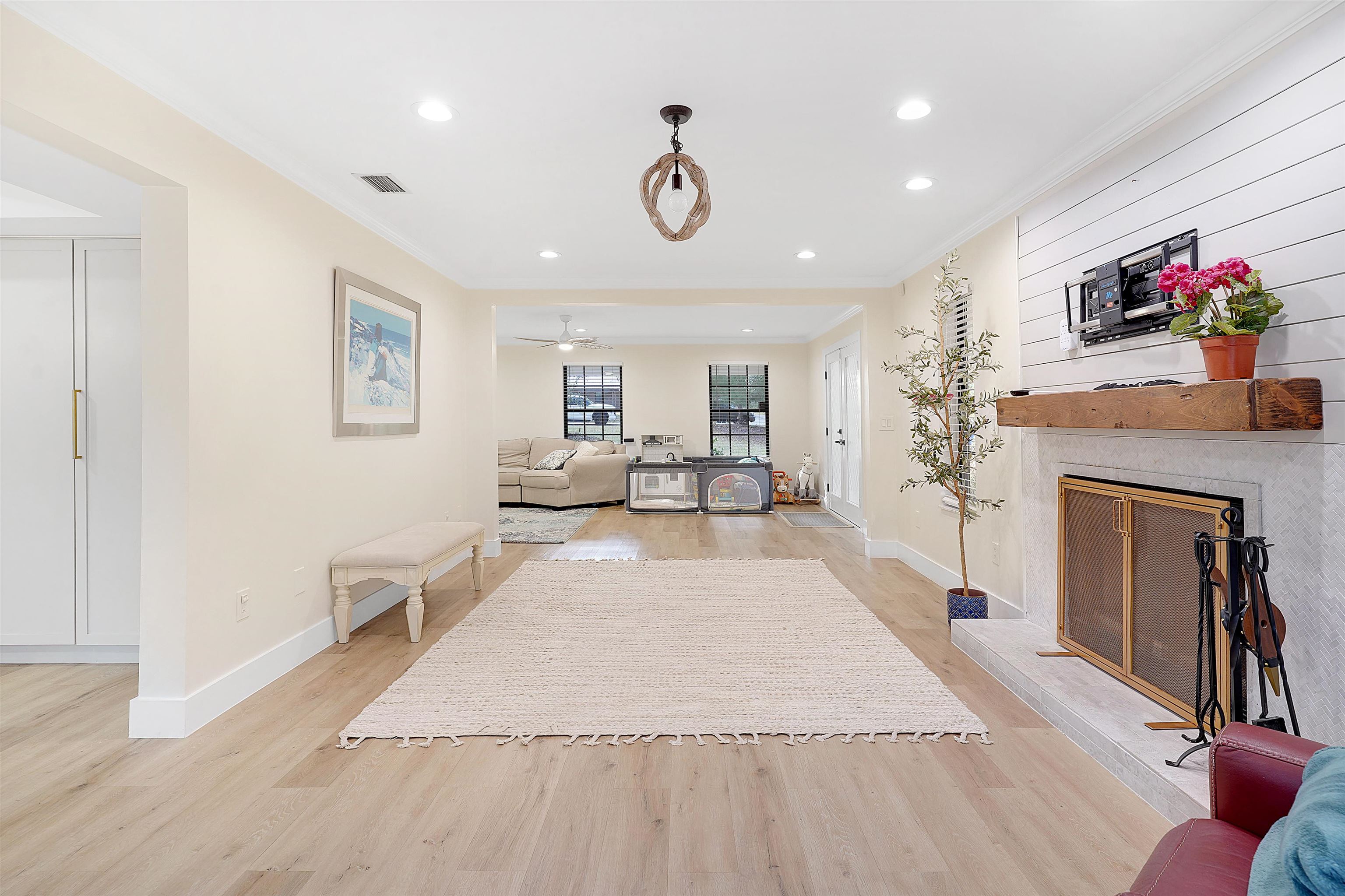 3020 Mac Road St. Augustine, FL 32086 - Photo 12 of 49 Living room with light wood-style flooring, a premium fireplace, crown molding, recessed lighting, and ceiling fan