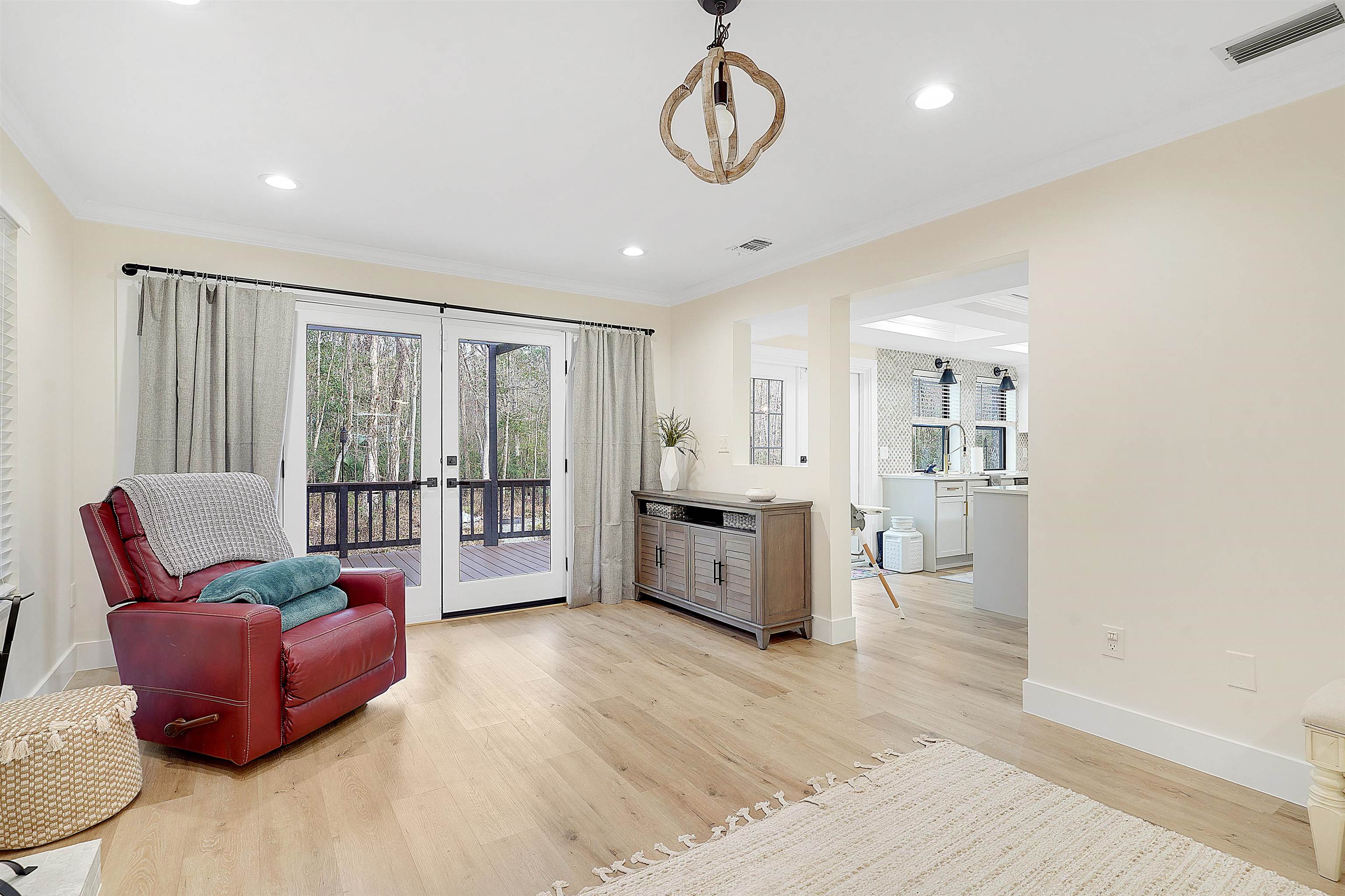 3020 Mac Road St. Augustine, FL 32086 - Photo 13 of 49 Sitting room with french doors, light wood-style flooring, plenty of natural light, recessed lighting, and ornamental molding
