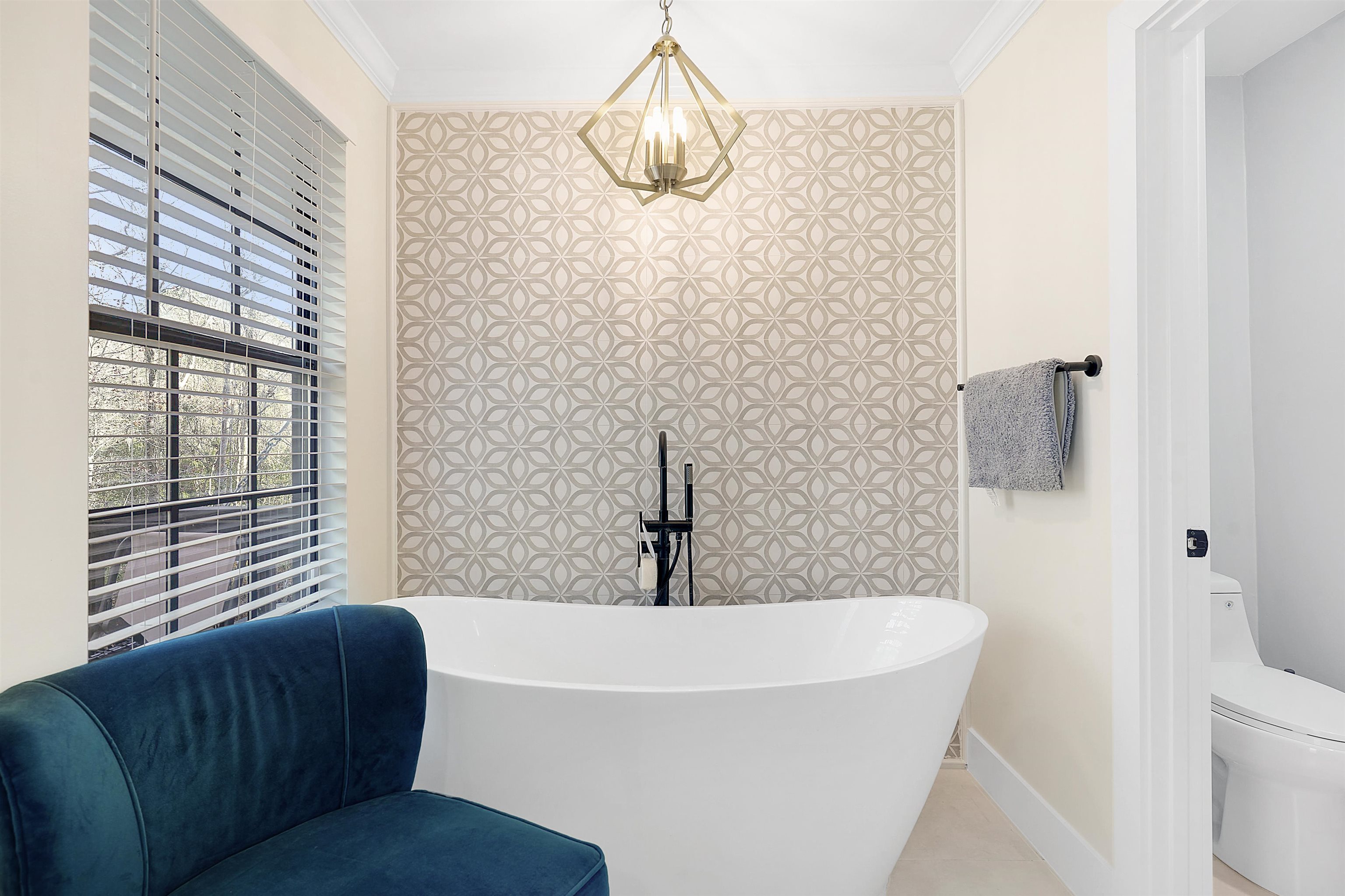 3020 Mac Road St. Augustine, FL 32086 - Photo 22 of 49 Bathroom with a freestanding tub, tile patterned floors, and ornamental molding